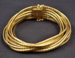Pulseira italiana em ouro 750 contrastada com 11 fios articulados em ouro escovado - med. 19 cm (aberta) - peso aproximado 68.5 gramas.