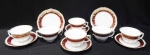 Seis xícaras para chá em porcelana branca esmaltada com faixa bordô e desenhos florais com frisos  dourados no acabamento. Marca Barão do Rio Branco. Altura de 6 cm.