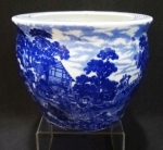 Cachepo ao gosto inglês em porcelana esmaltada com cena de fazenda na tonalidade azul cobalto e bordas desenhadas. Altura de 15 cm.